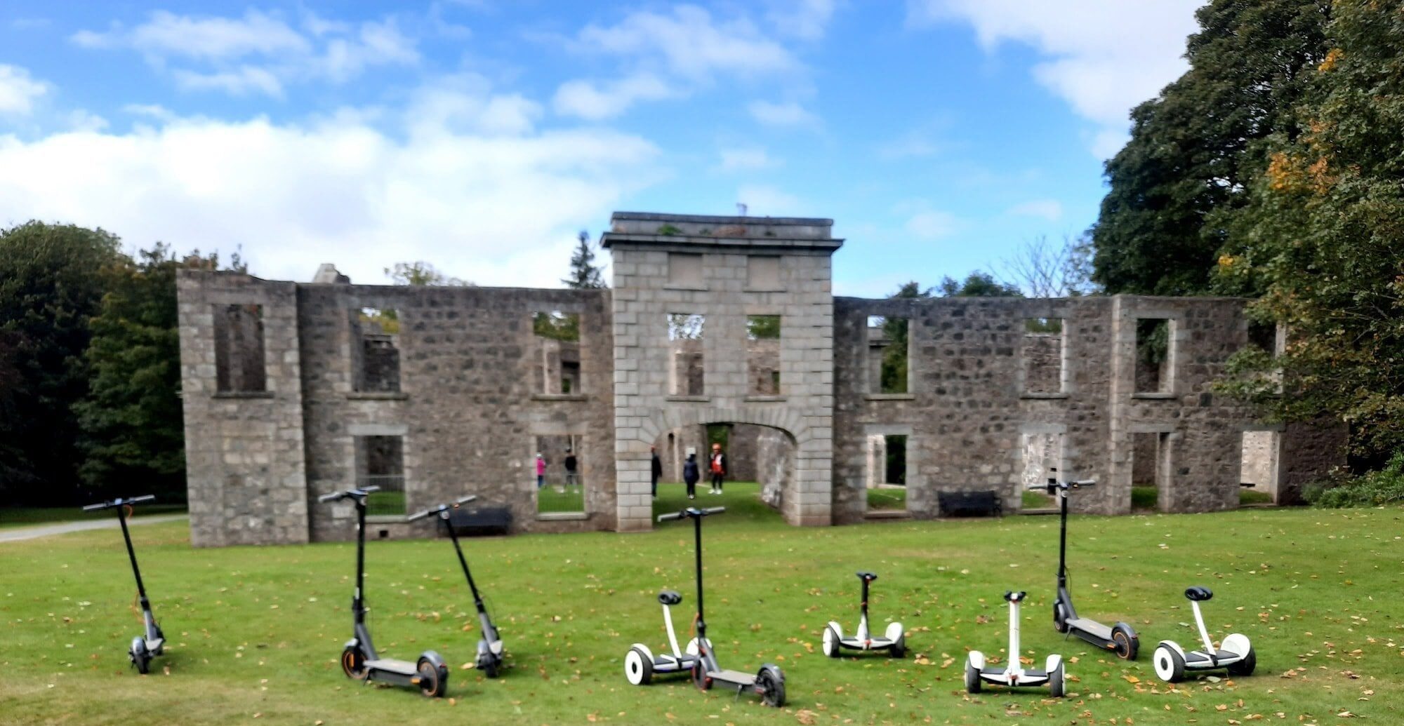A number of scooters outside a ruin